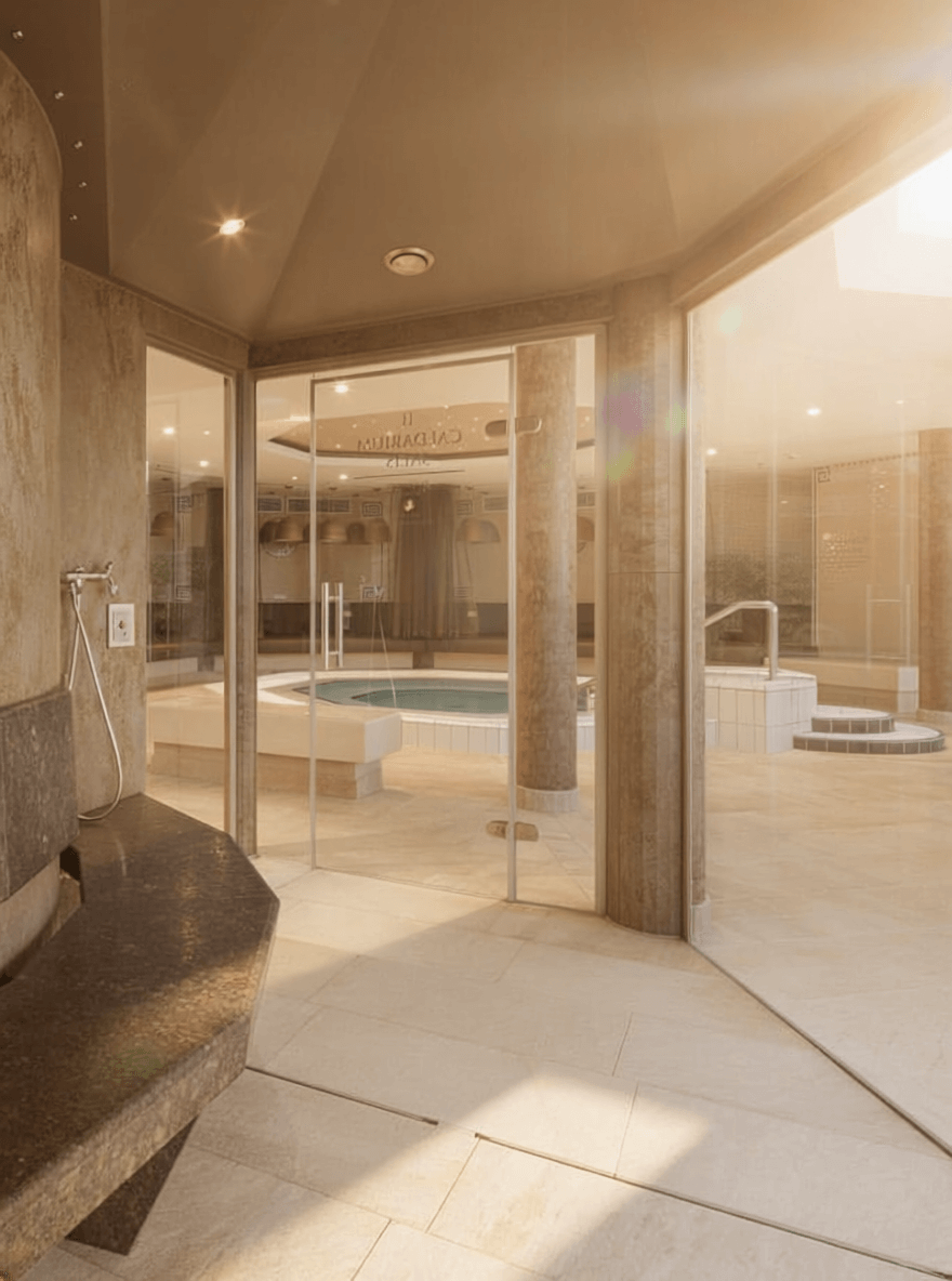 Interior of a wellness area with glass wall, column and whirlpool