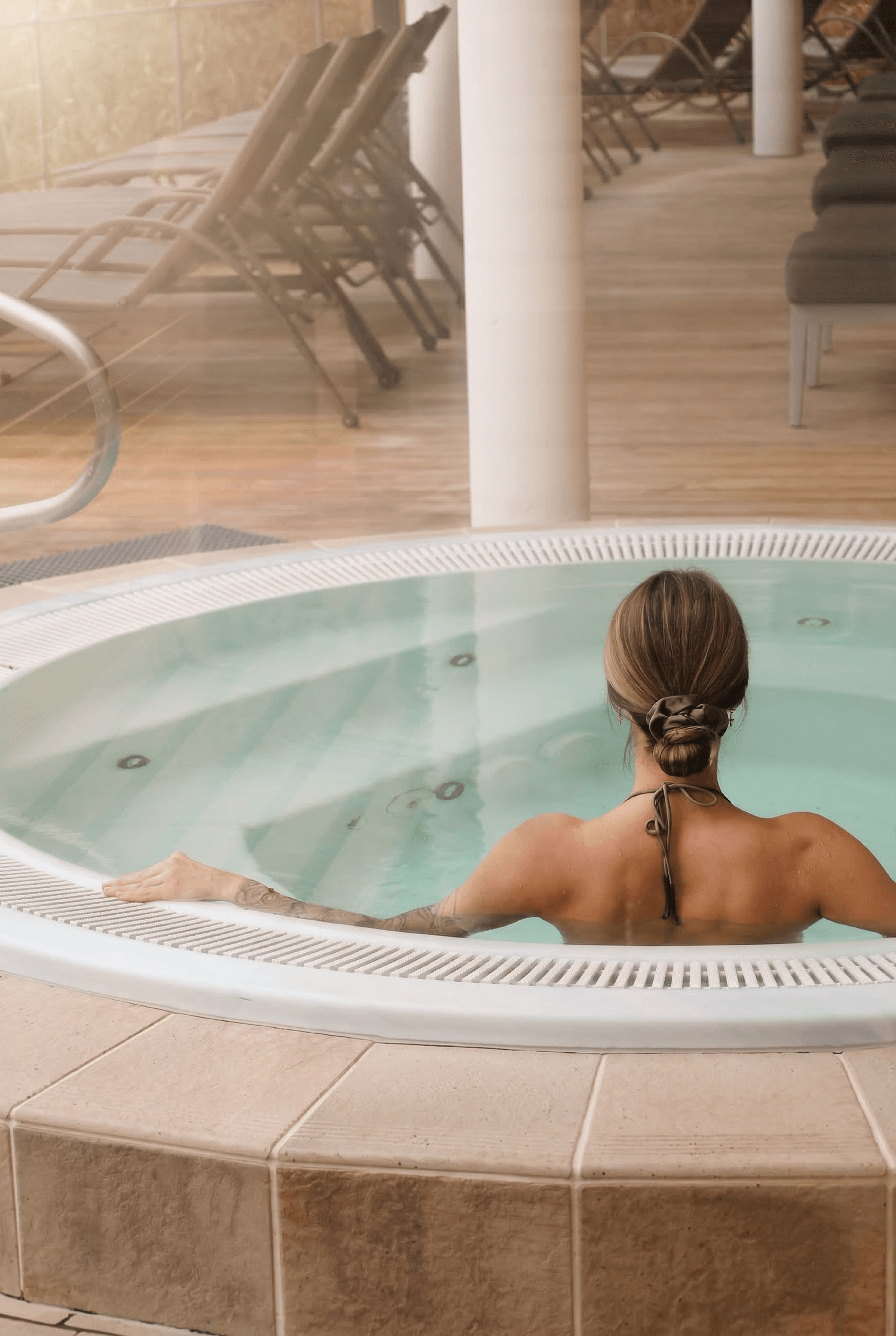 eine Frau sitzt im Whirlpool 