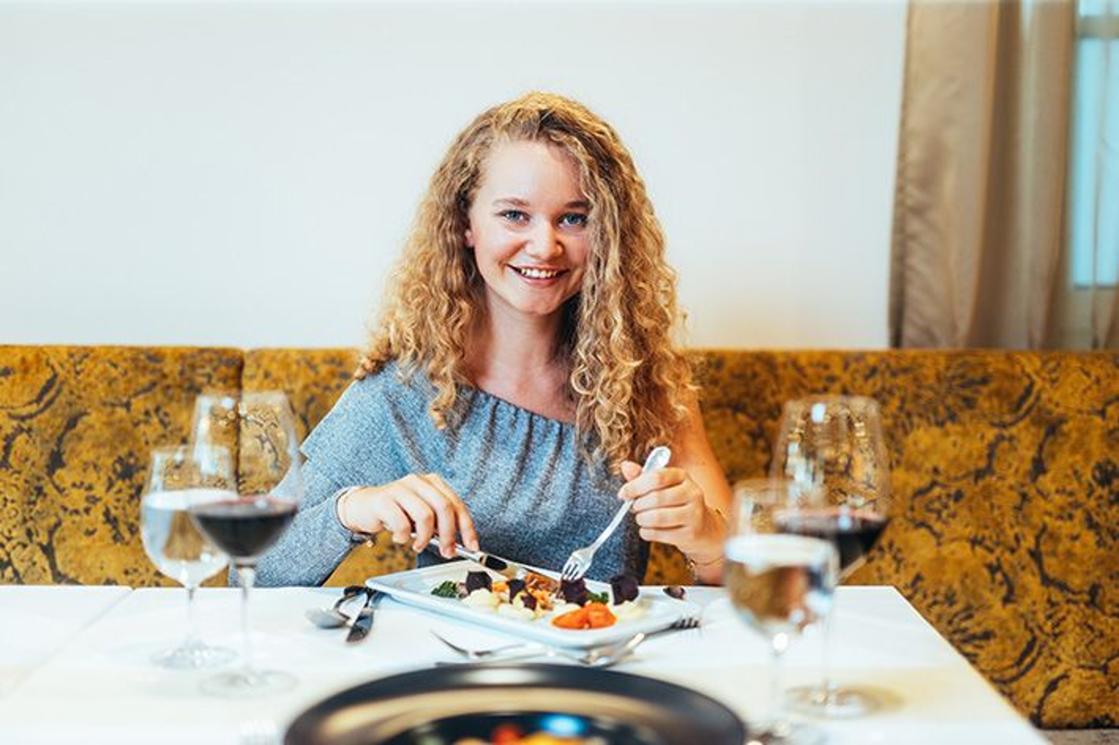 A woman  enjoying an after-work dinner.