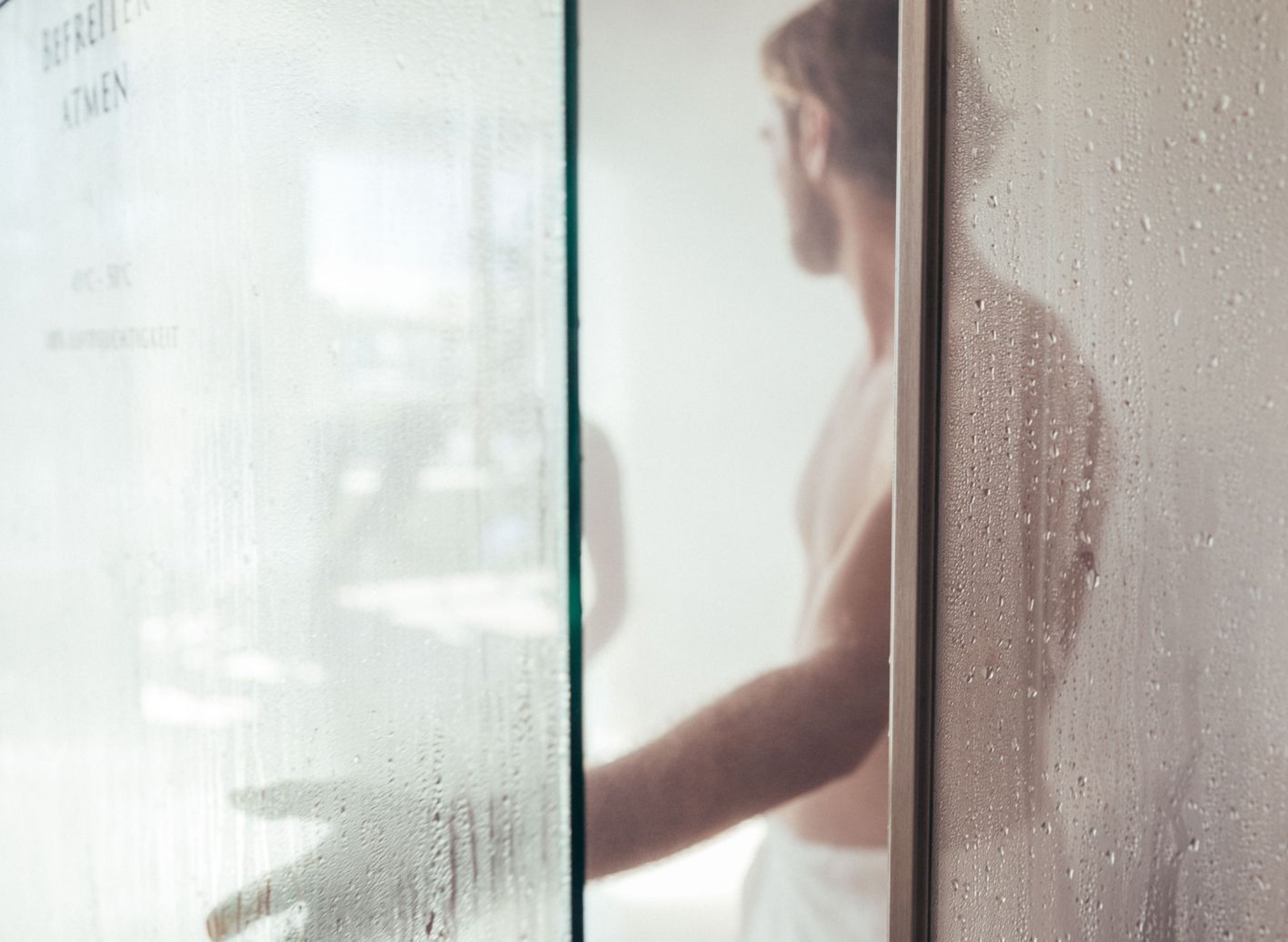 A person opens the door to a steam bath.
