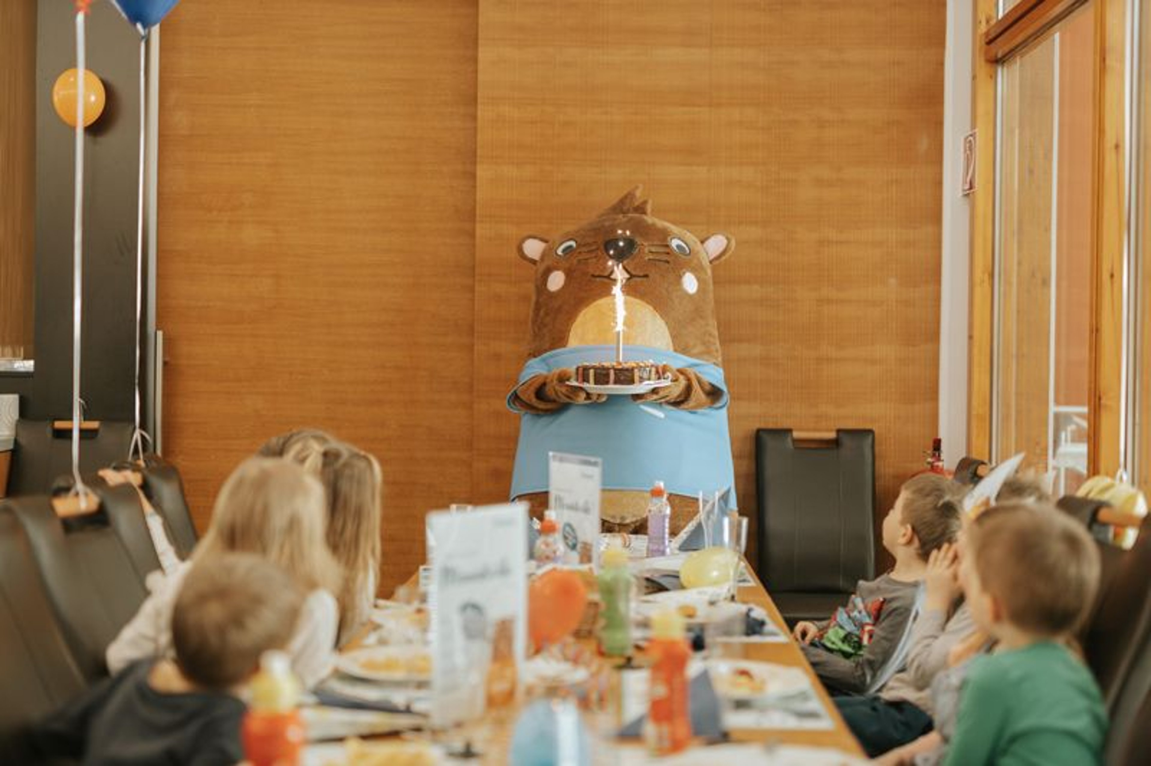 Otto brings a chocolate cake to the birthday table