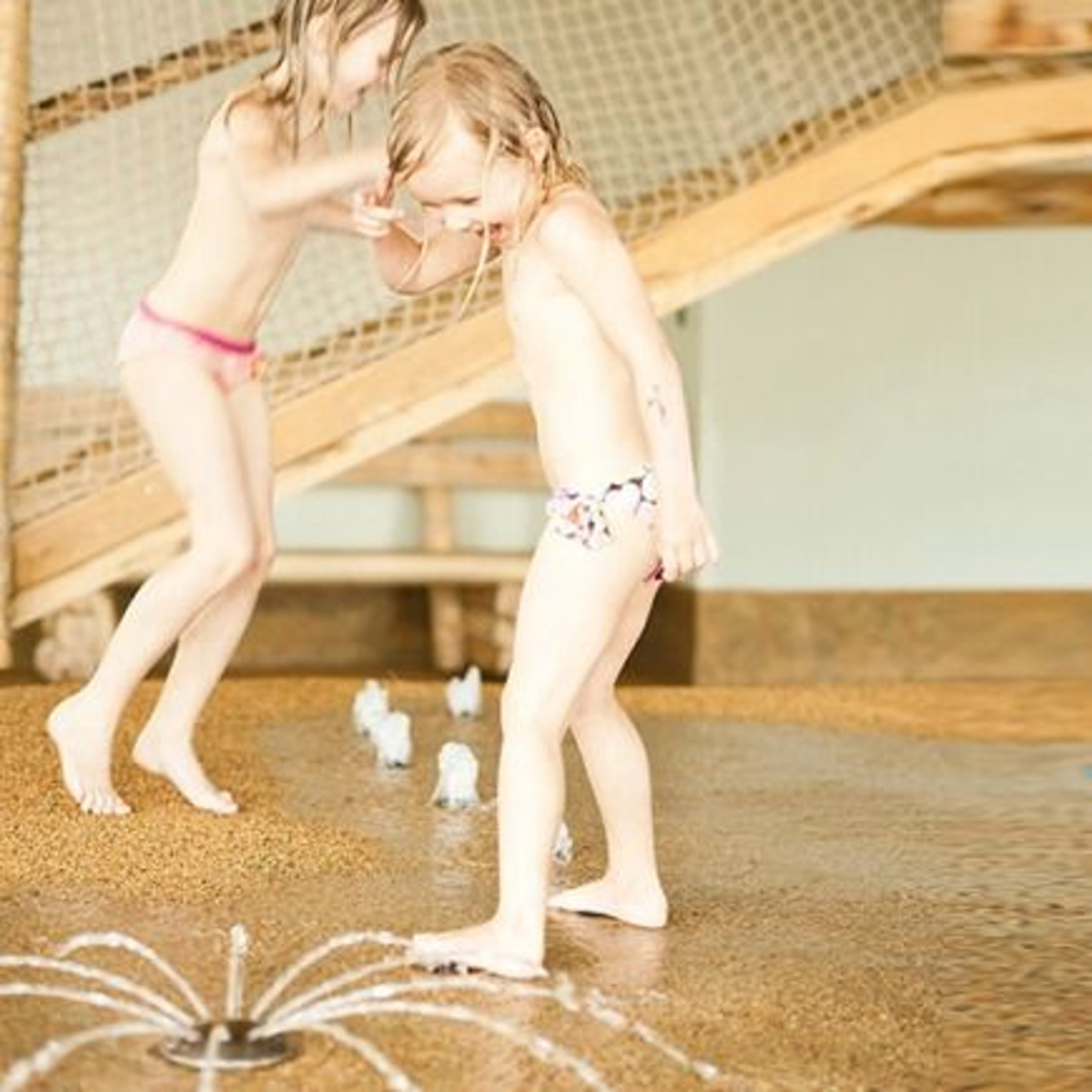 Two small children playing with water.
