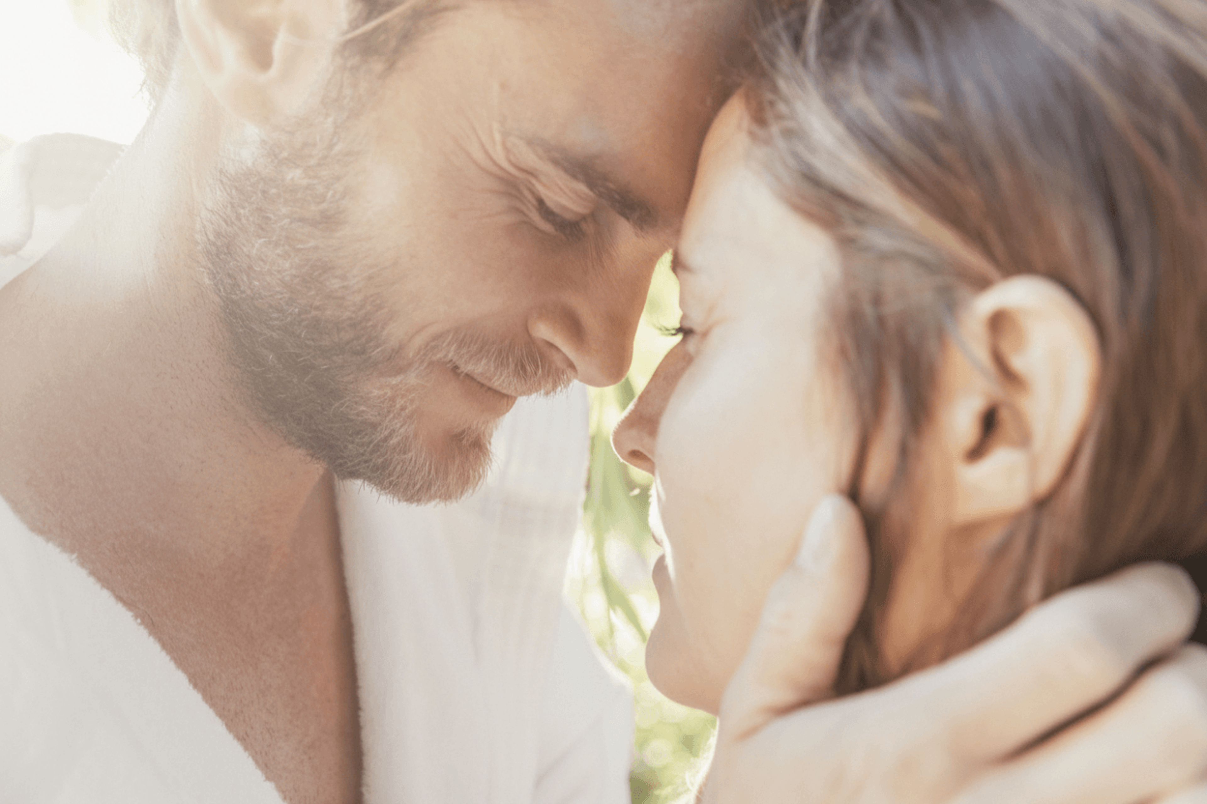 Close-up of a bearded man gently tilting his head to the side