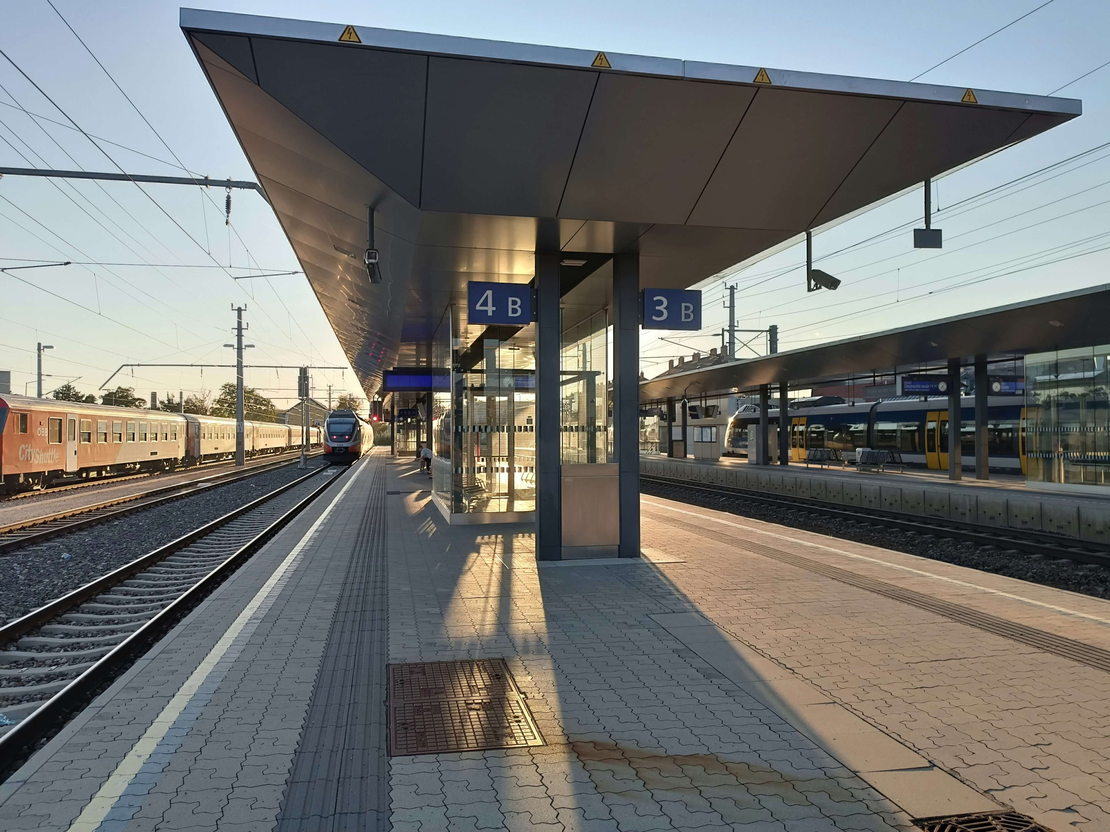 View of a platform with a train entering the station.