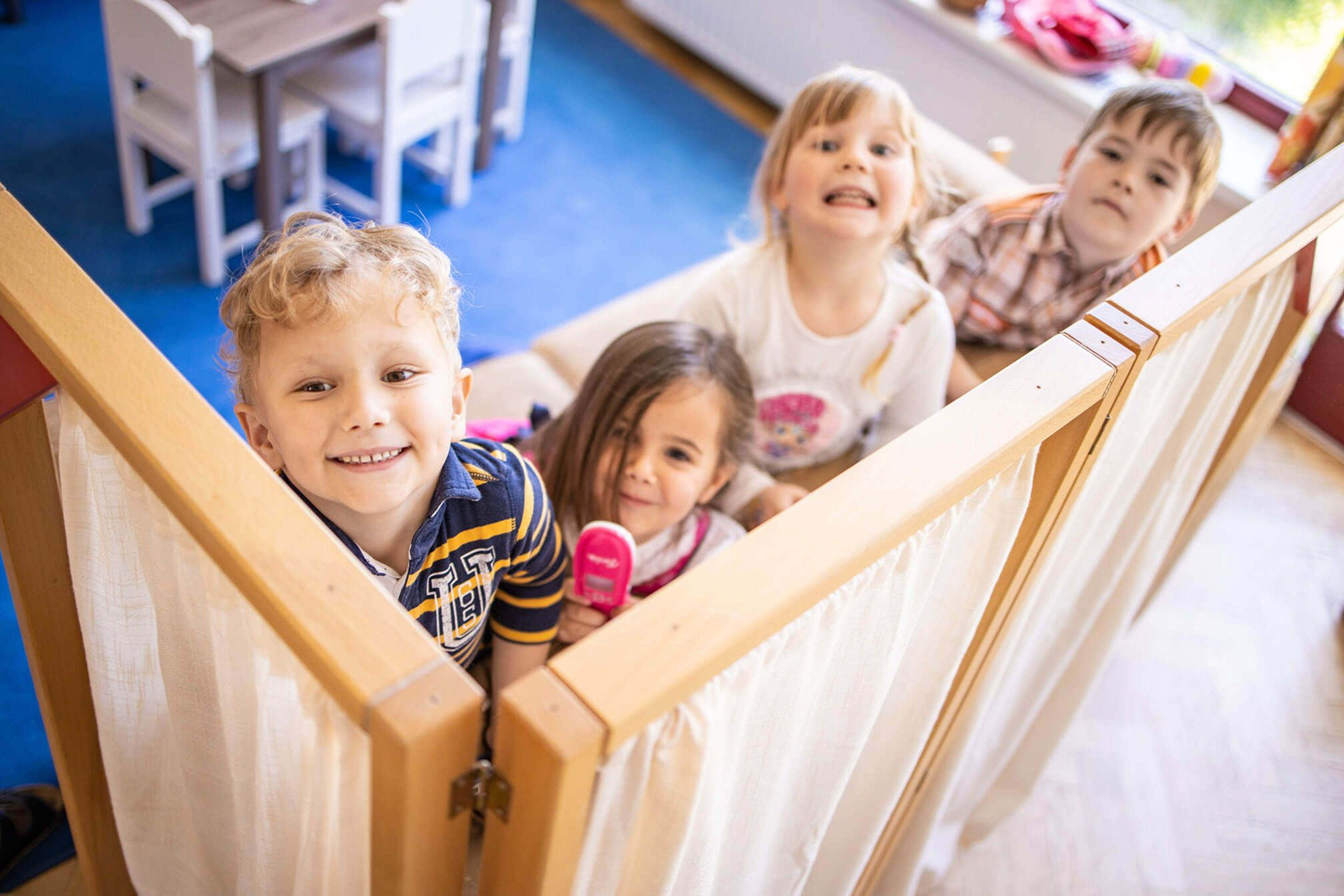 The children from the tourist kindergarten play hide and seek.