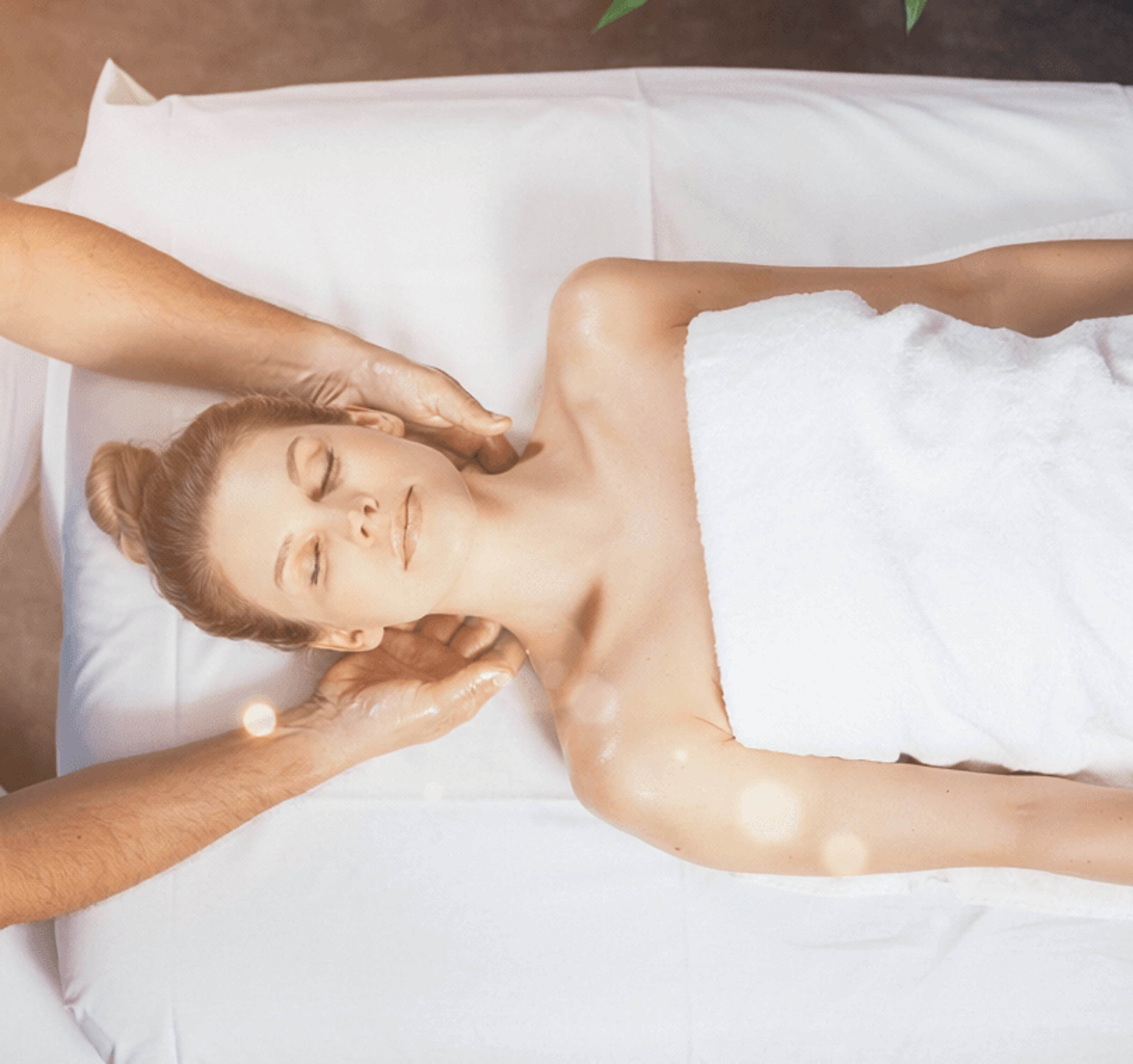 Therapist giving a massage to a guest lying on a massage table, viewed from above