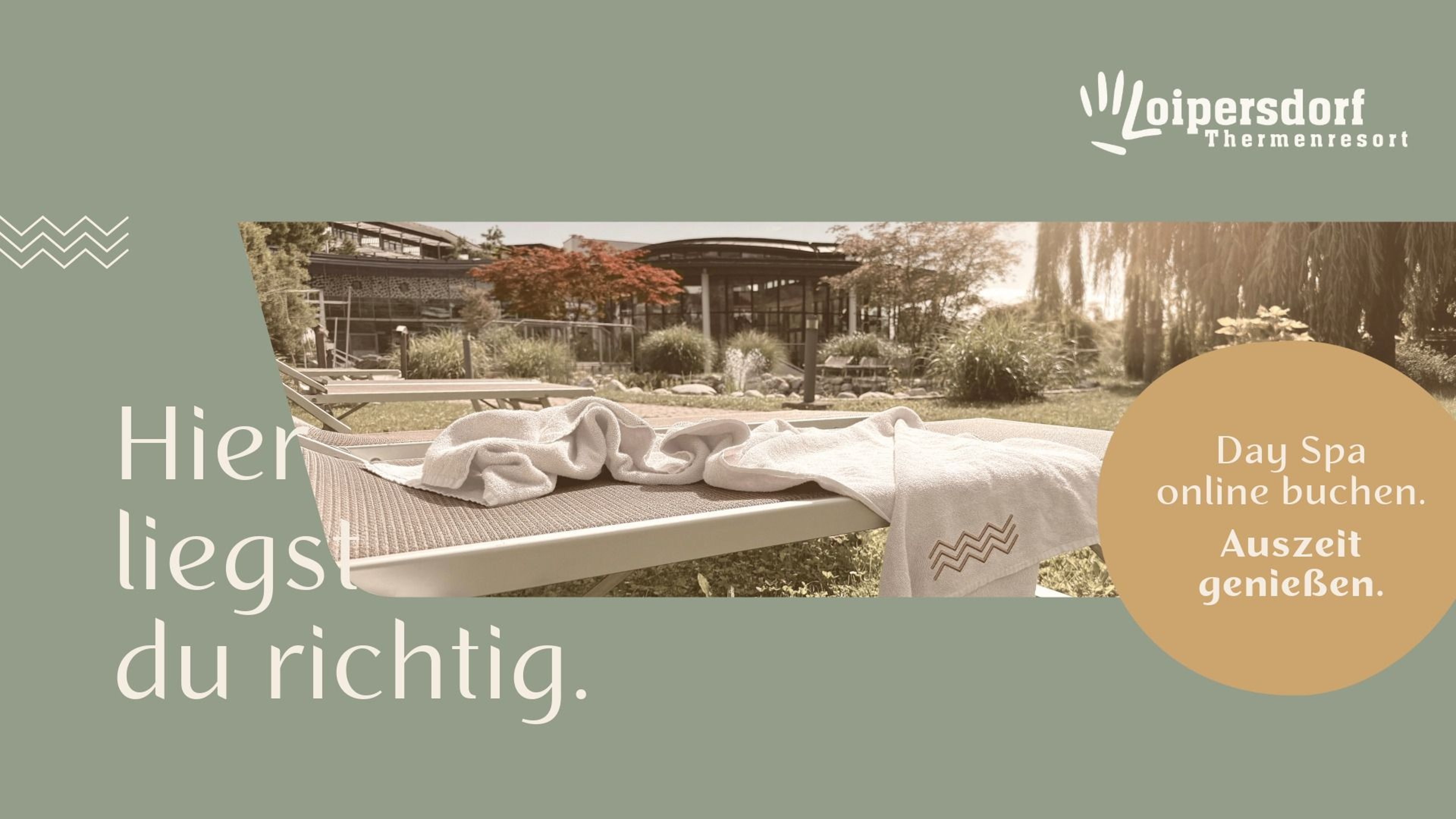 Lounge chair with towels on a terrace in front of a building with trees in the background