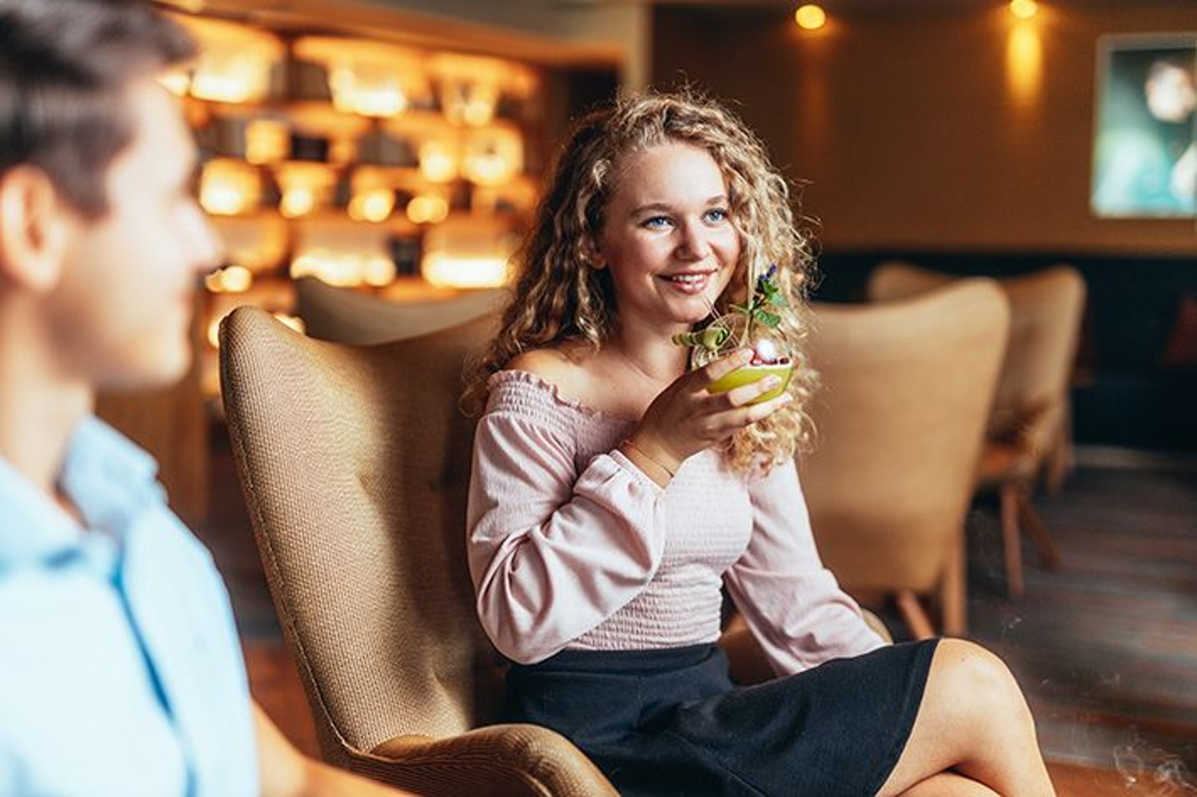 A woman enjoying a cocktail in the Sunny Bar.