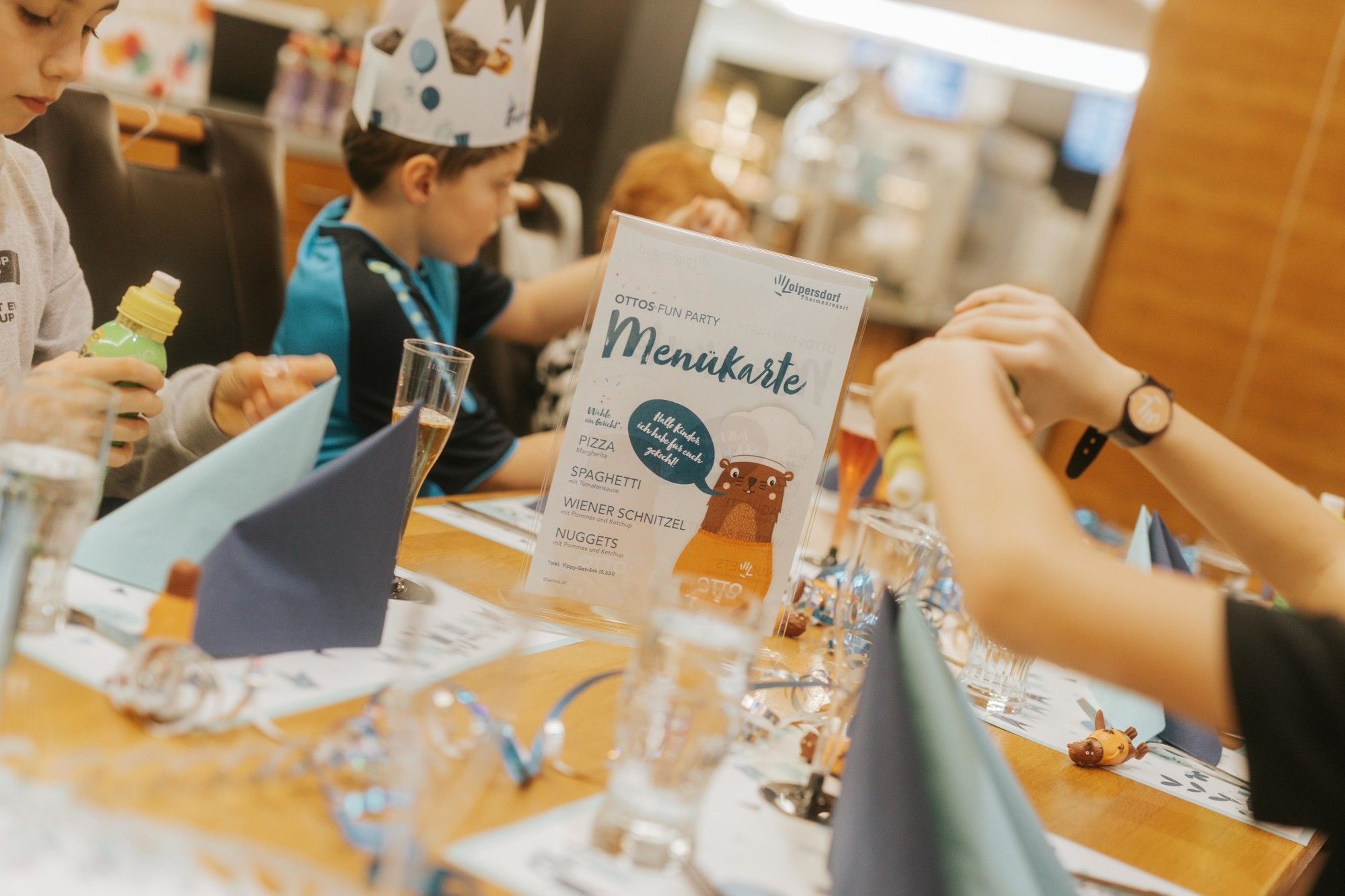 A colorful birthday table with a menu card in the middle