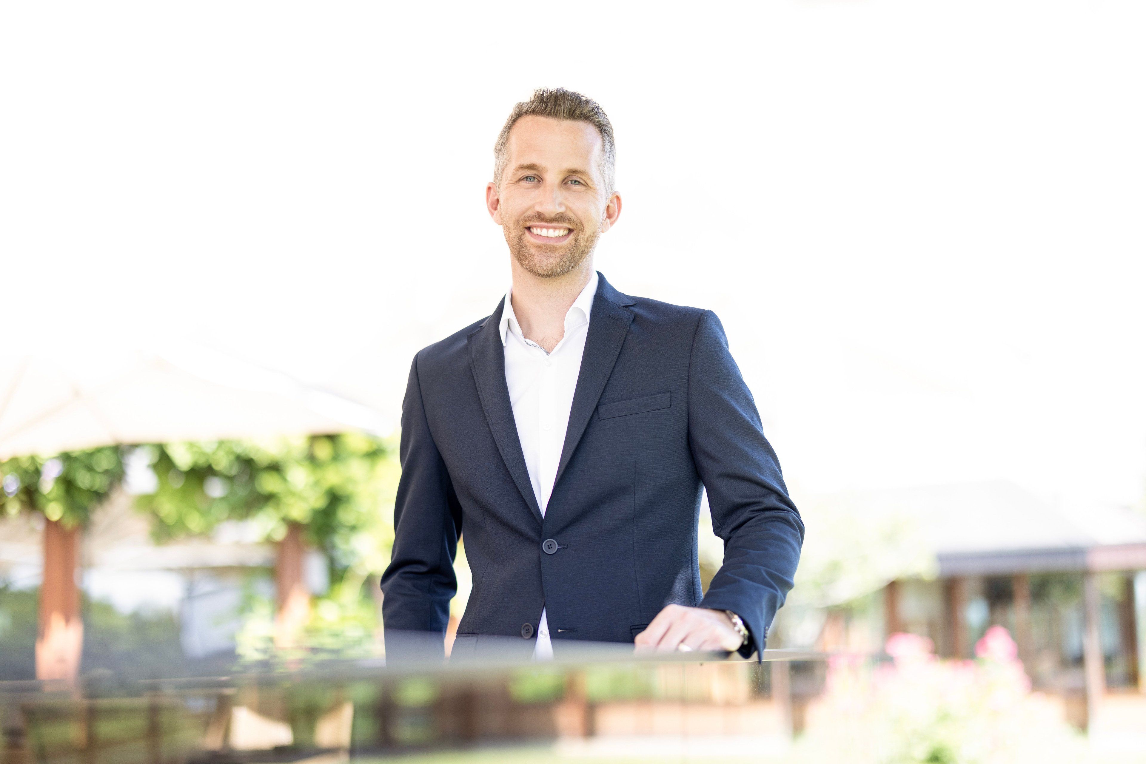 Man in suit with blurred face against blurred background.