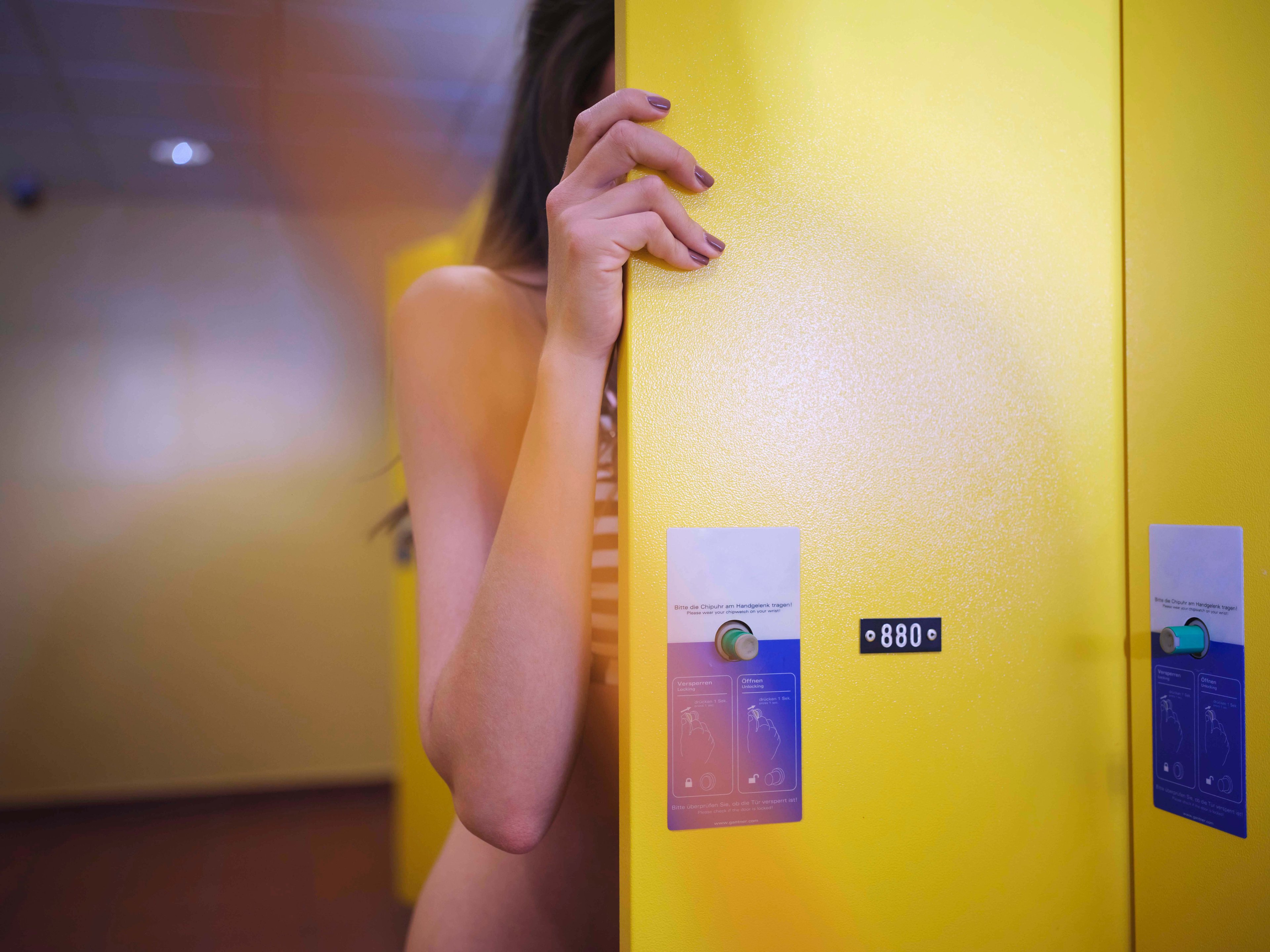 Bathing guest opens the yellow changing room at the Loipersdorf thermal spa resort.