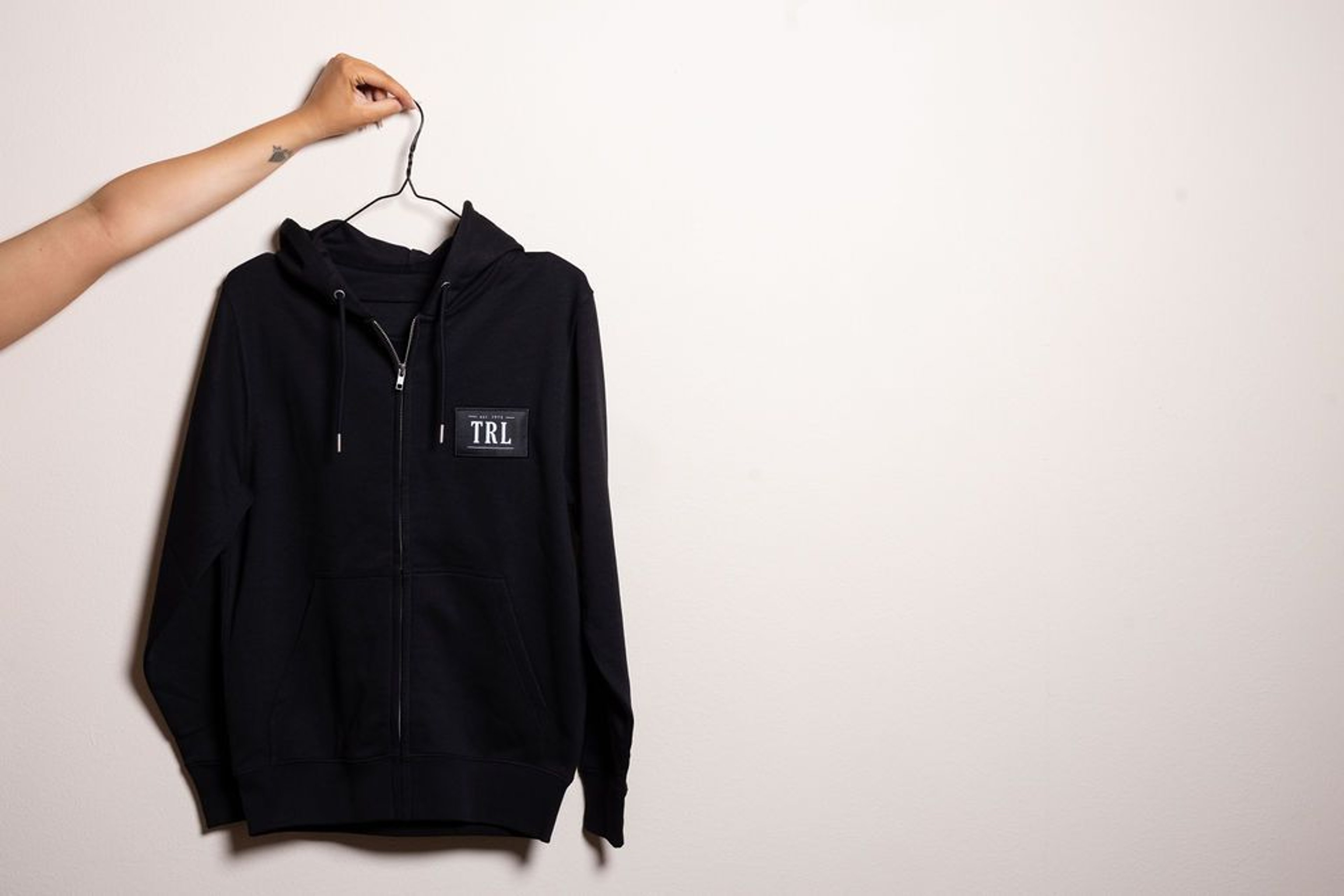 Modern black sweater jacket with the Thermenresort Loipersdorf branding on the chest, the perfect companion for cooler evenings after a day at the spa.