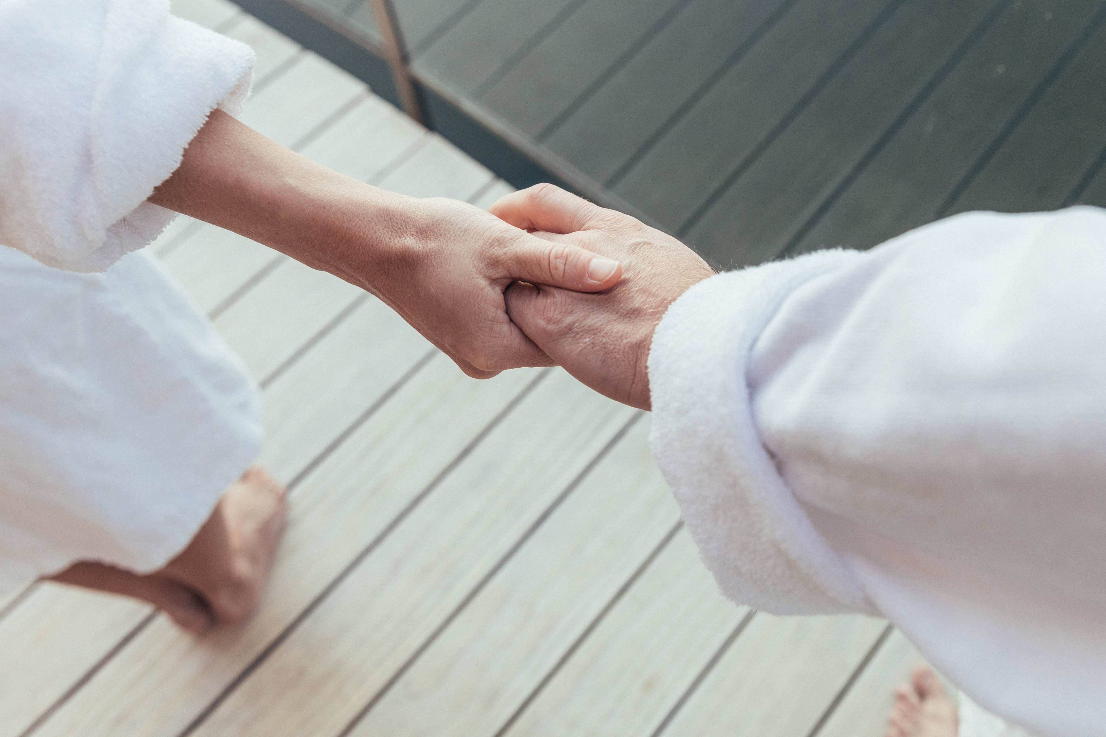 Two people shake hands.