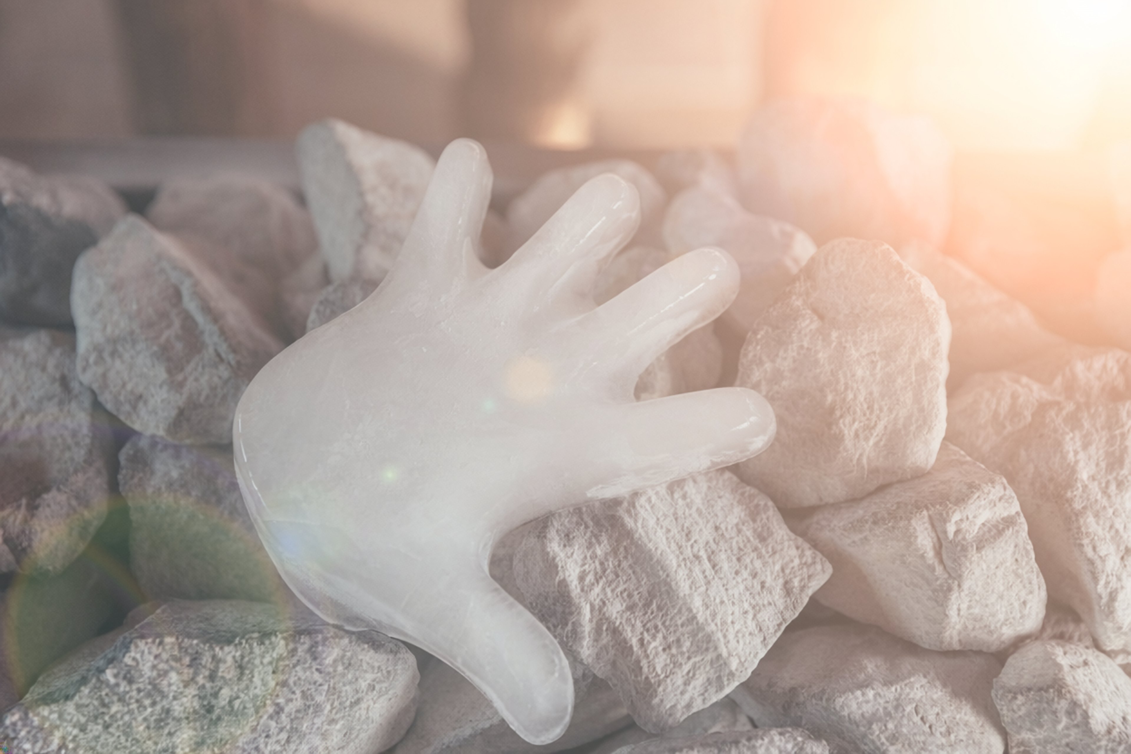 An ice cube is resting on the sauna stones