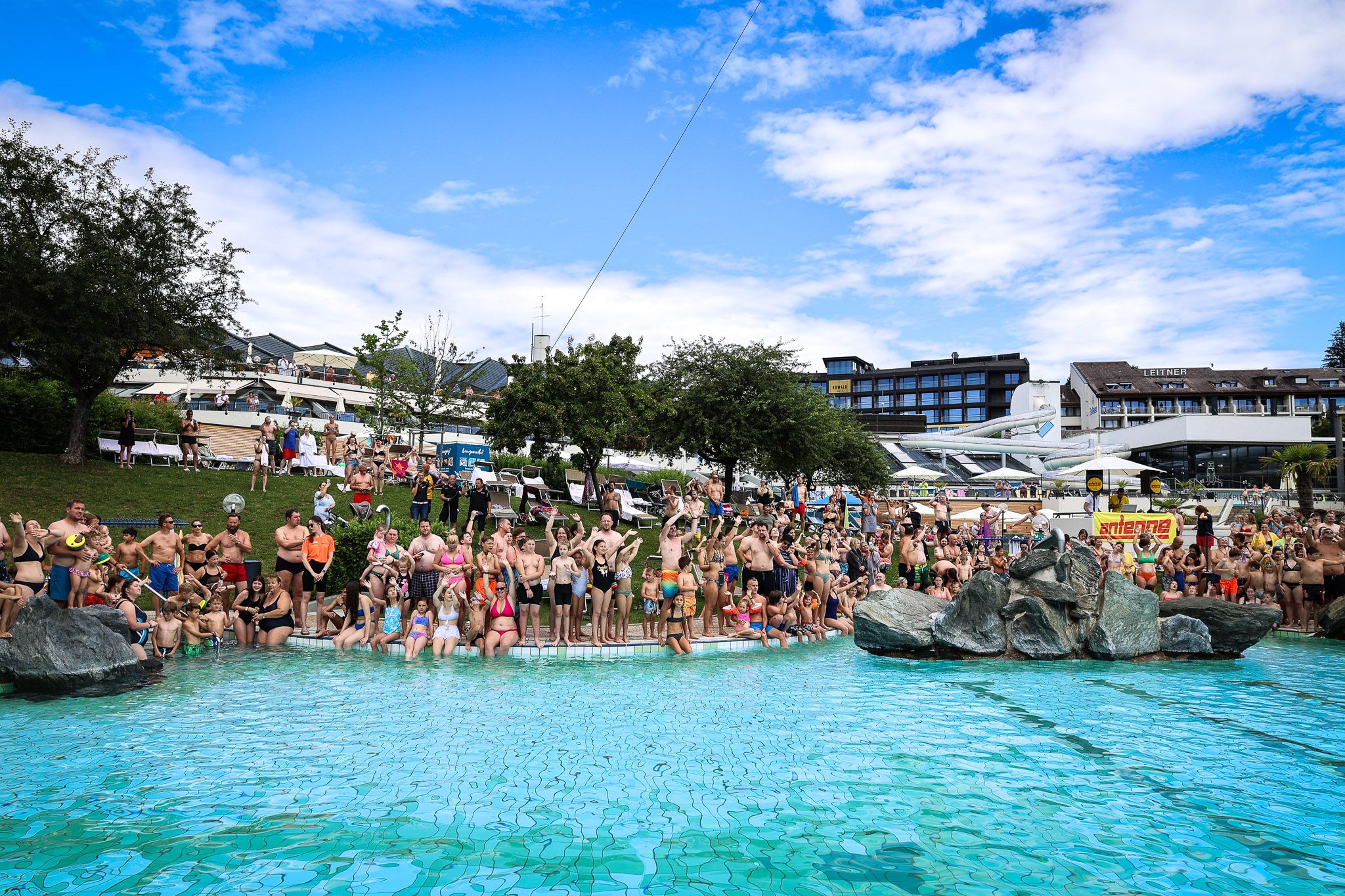 Lots of guests standing around the Acapulco pool