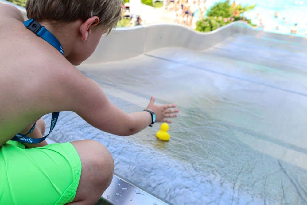 Child lets duck down the wave slide