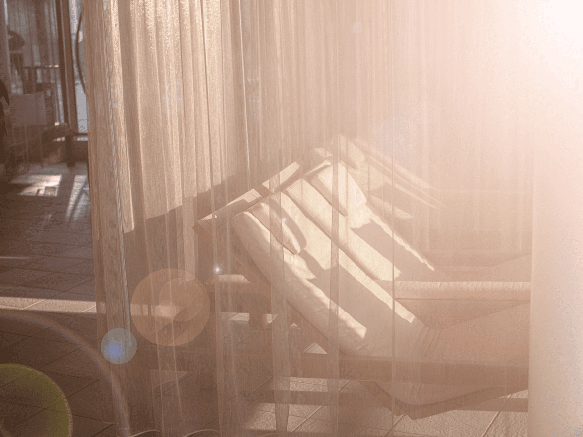 Snuggling behind a curtain.