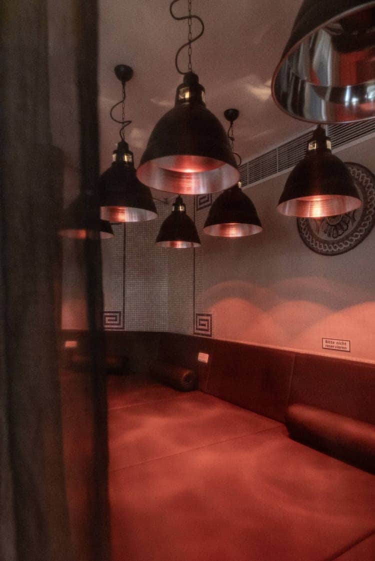 The infrared lamps illuminate the sauna in red